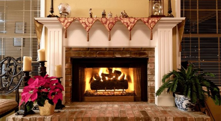 A cozy fireplace scene with holiday decorations and a roaring fire.